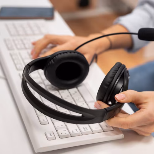 woman-working-call-center-holding-pair-headphones_23-2149256146